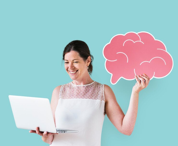 Mujer sosteniendo un icono del cerebro y usando una computadora portátil